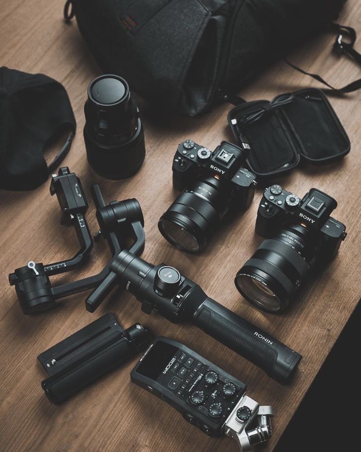 Two Sony cameras, a Ronin gimbal, lenses and a Zoom audio recorder laid out on a table
