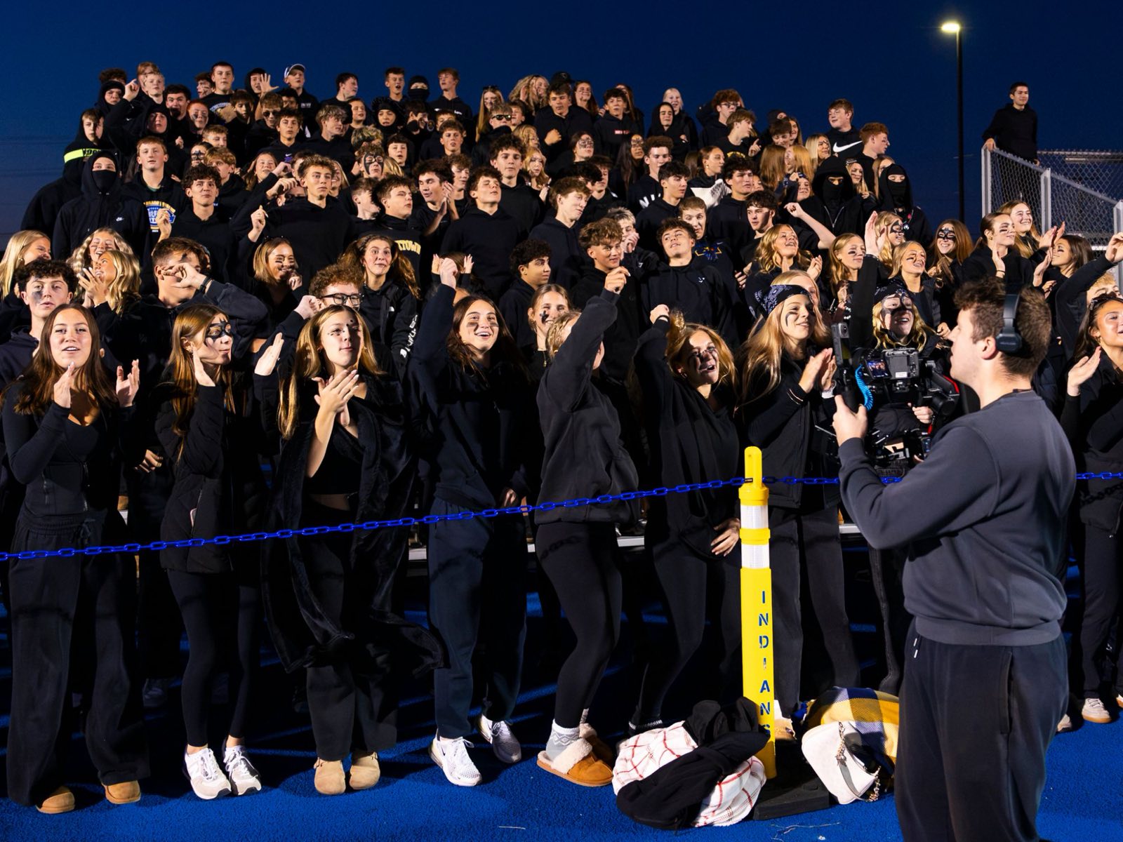 Ethan Jaworski filming the Mukwonago student section with a gimbal under the lights