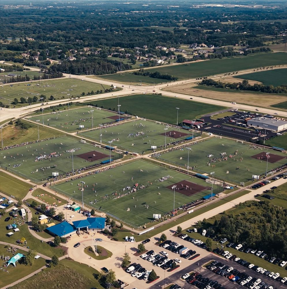 Aerial view of a multi-field sports complex on tournament day